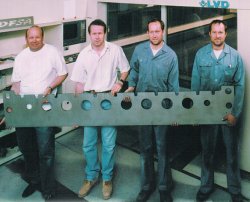 Holding a recently cut piece part are the Fracheboud brothers (from left) Daniel, Maurice, Stephane, and Julien.
